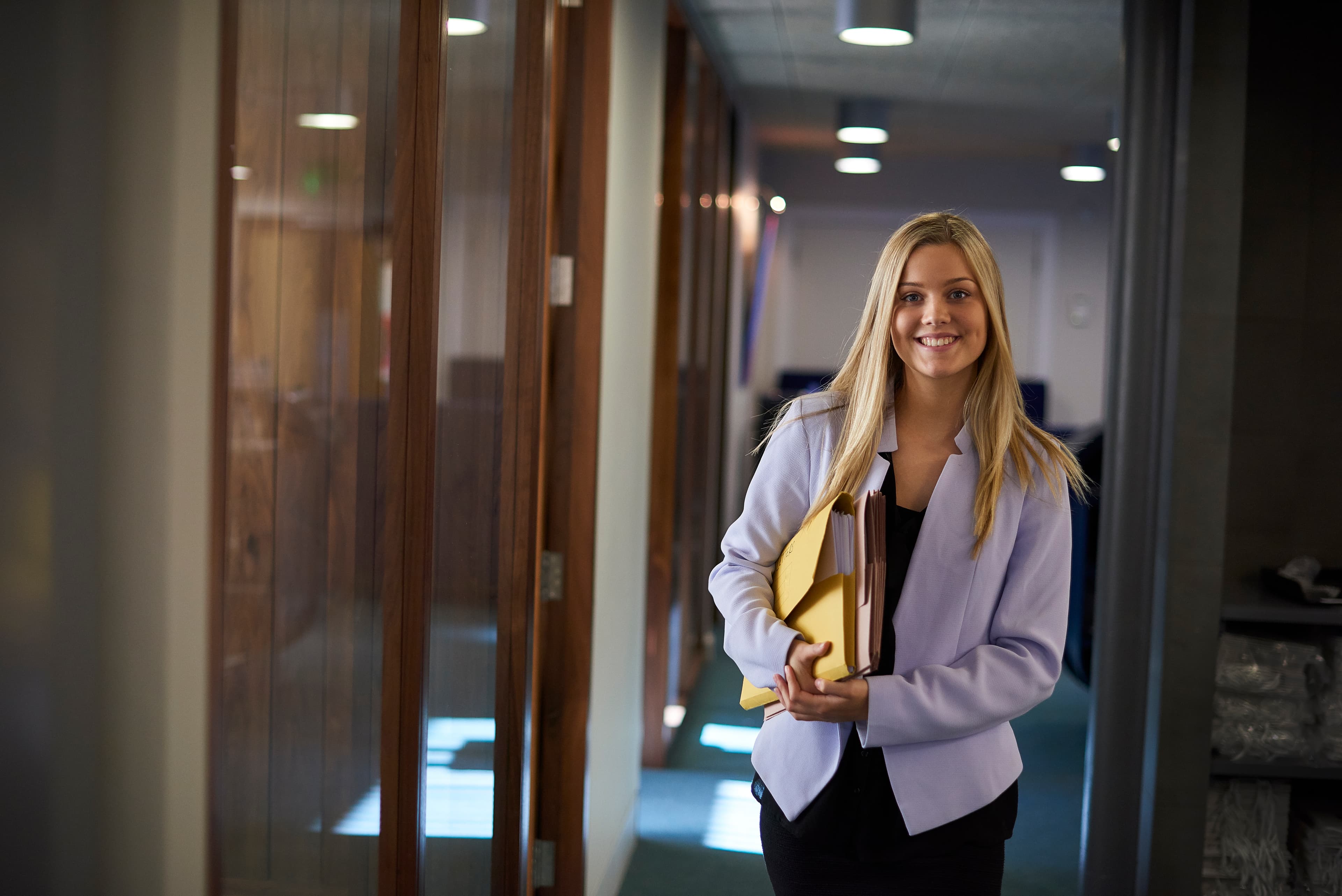 A student in professional attire working in an office