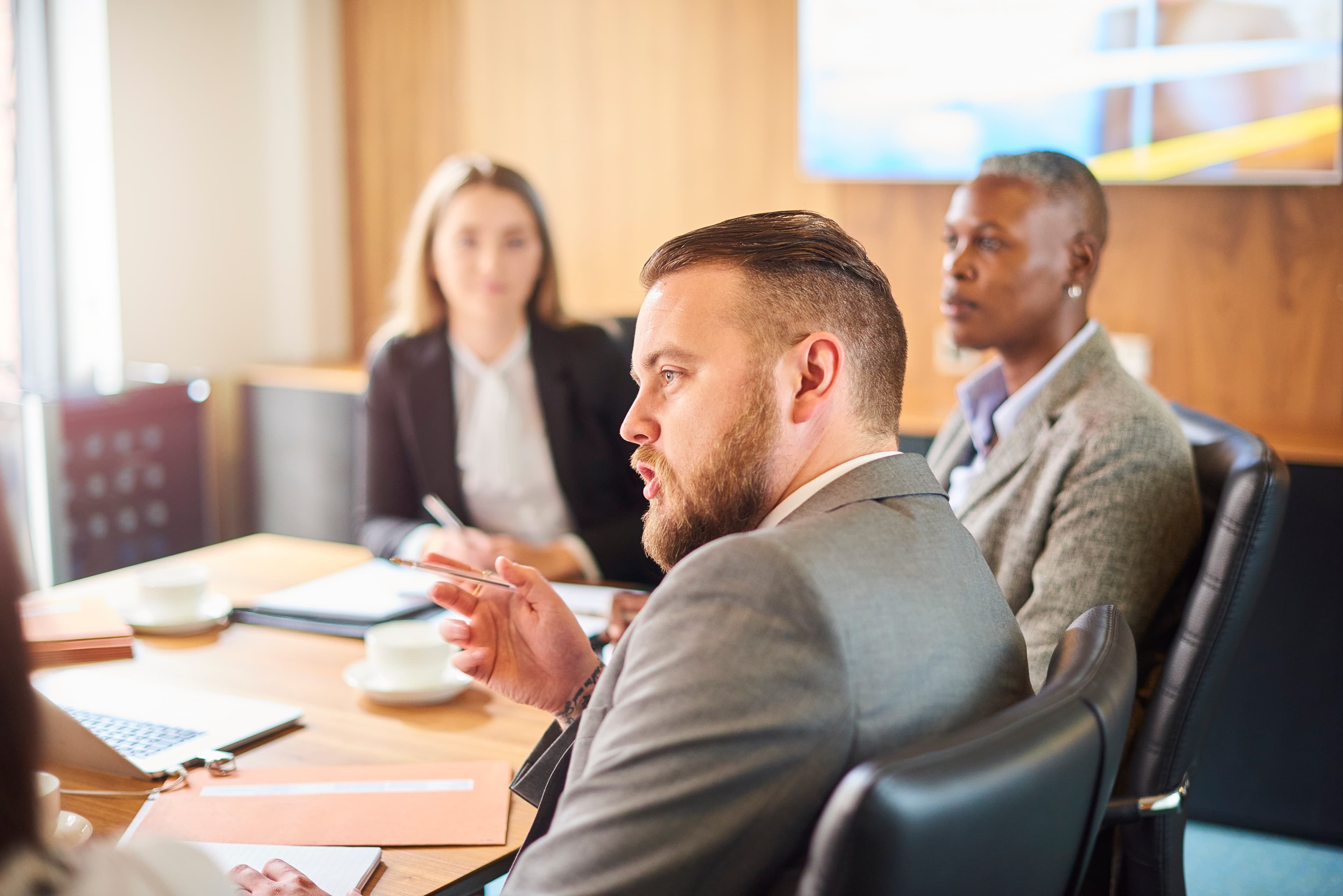 An attorney presenting a written work product to colleagues in an office